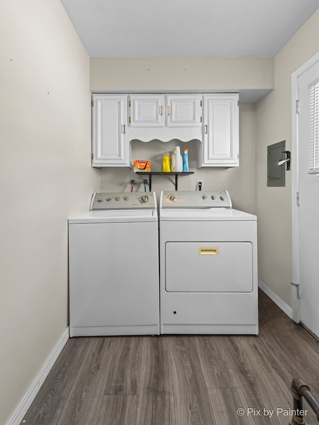 laundry room featuring washing machine and dryer, dark hardwood / wood-style floors, and cabinets