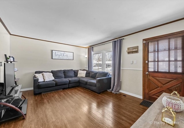 living room featuring dark hardwood / wood-style flooring and crown molding