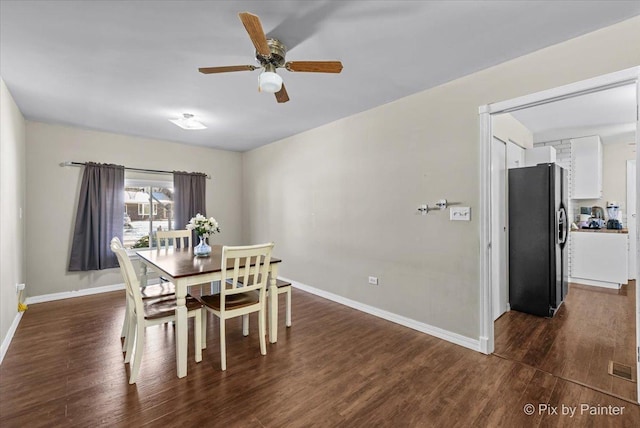 dining space featuring ceiling fan and dark hardwood / wood-style floors