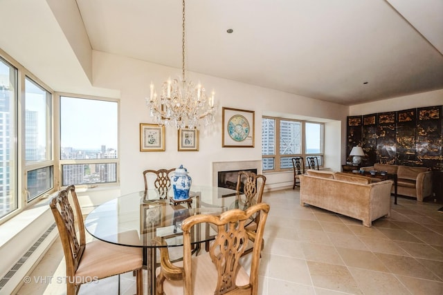 tiled dining room with a chandelier