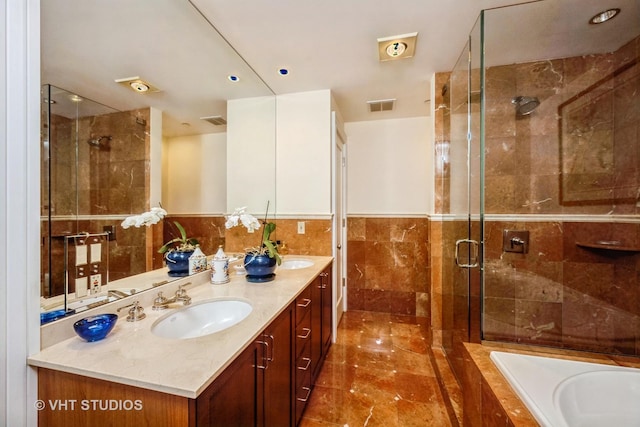 bathroom with vanity, separate shower and tub, and tile walls