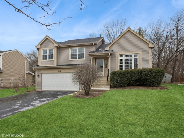 view of front of home featuring a garage and a front lawn