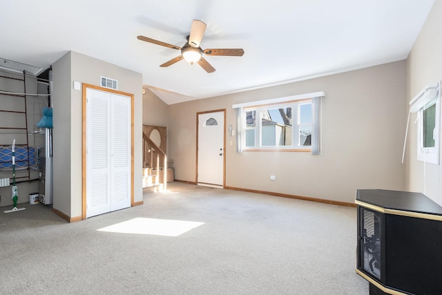 interior space featuring light carpet and ceiling fan