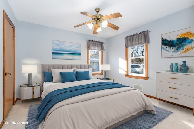 bedroom with ceiling fan and light colored carpet