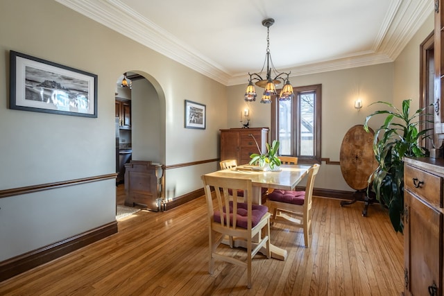 dining room with crown molding and light wood-type flooring