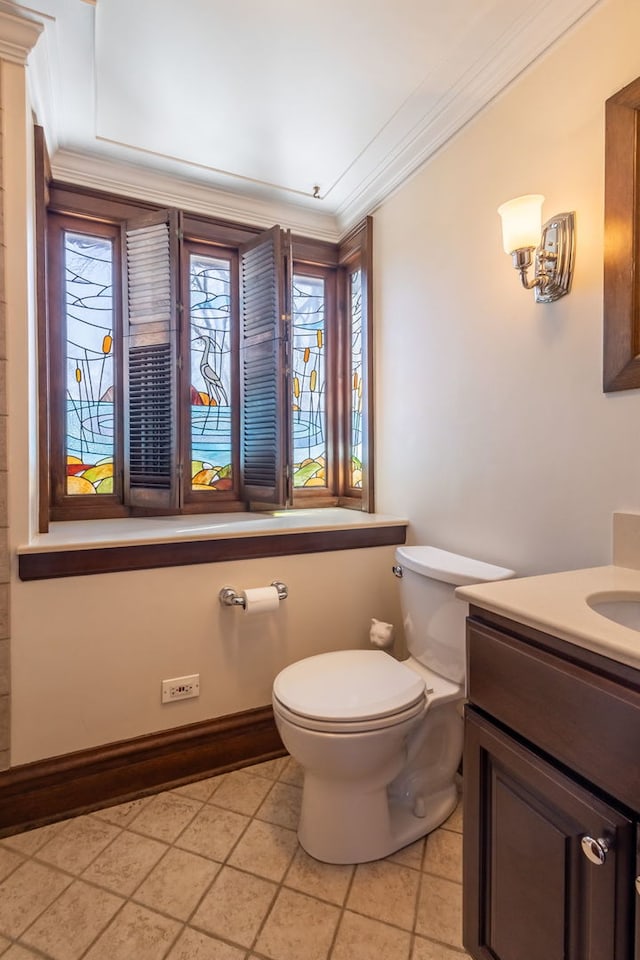 bathroom featuring ornamental molding, tile patterned floors, toilet, and vanity