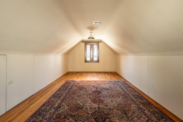 additional living space with lofted ceiling and light hardwood / wood-style floors