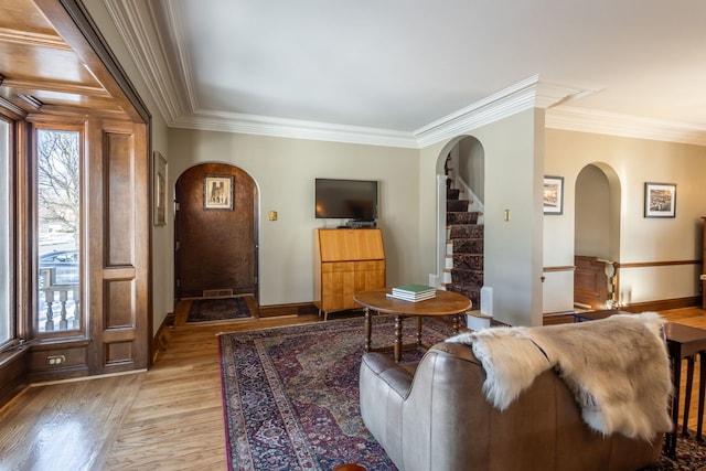 living room with crown molding and light hardwood / wood-style flooring