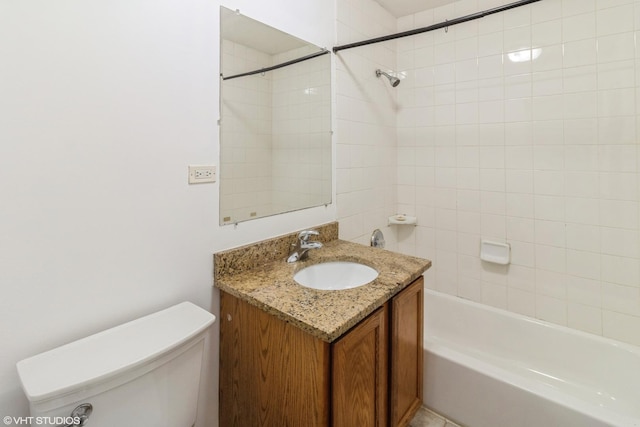 full bathroom with vanity, toilet, and tiled shower / bath