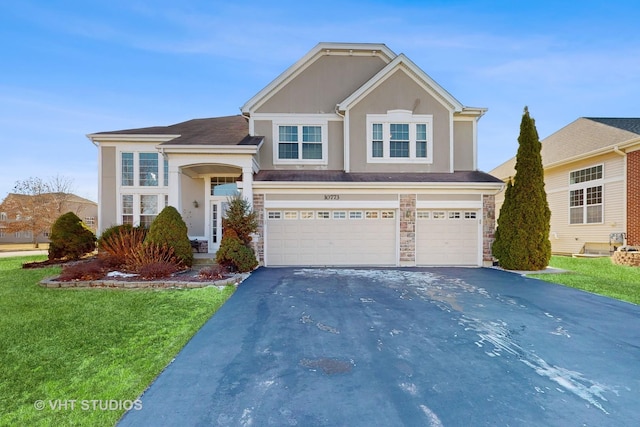 front facade with a garage and a front lawn