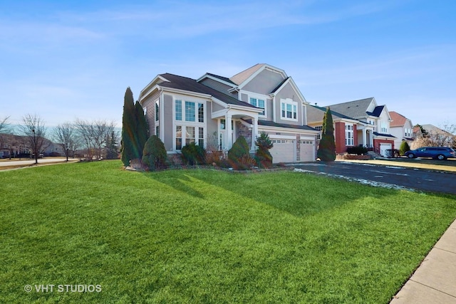 view of front property featuring a garage and a front lawn