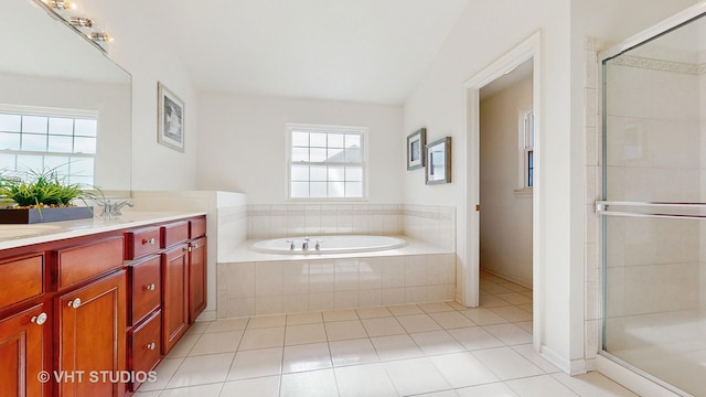 bathroom with tile patterned flooring, vanity, and shower with separate bathtub