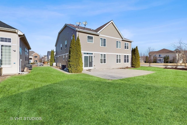 rear view of house featuring a lawn and a patio area