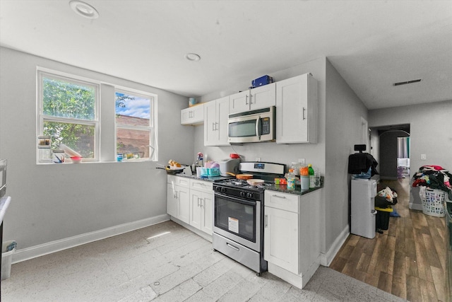 kitchen featuring white cabinets and appliances with stainless steel finishes