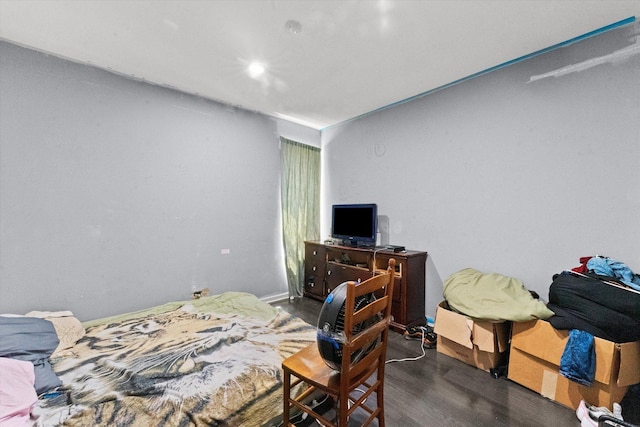 bedroom with dark wood-type flooring