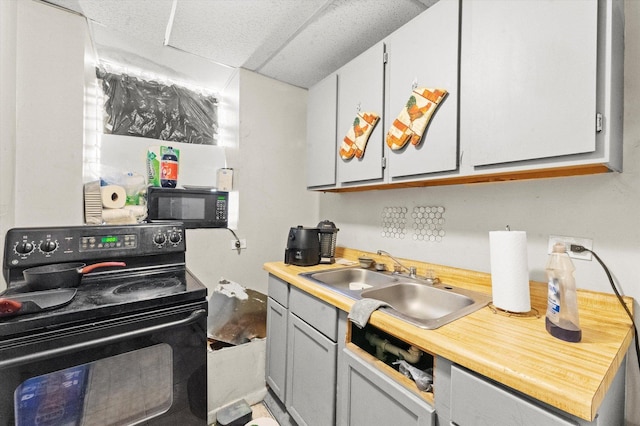 kitchen with black appliances, gray cabinets, and sink