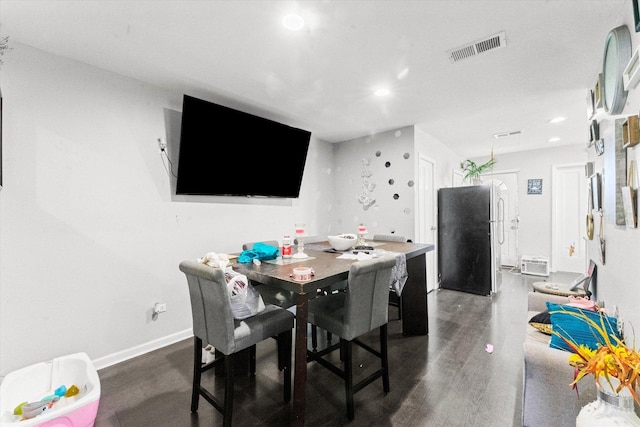 dining space with dark hardwood / wood-style floors