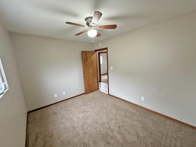 carpeted empty room featuring ceiling fan