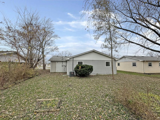 rear view of property featuring a lawn