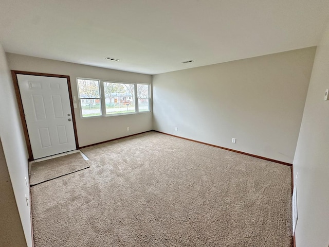 unfurnished room featuring light colored carpet