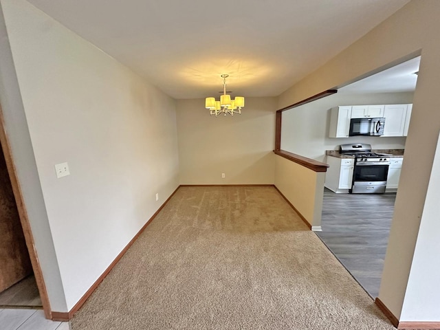 unfurnished dining area featuring light carpet and an inviting chandelier