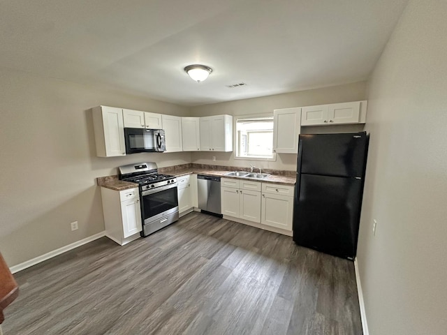 kitchen with black appliances, dark hardwood / wood-style floors, white cabinets, and sink