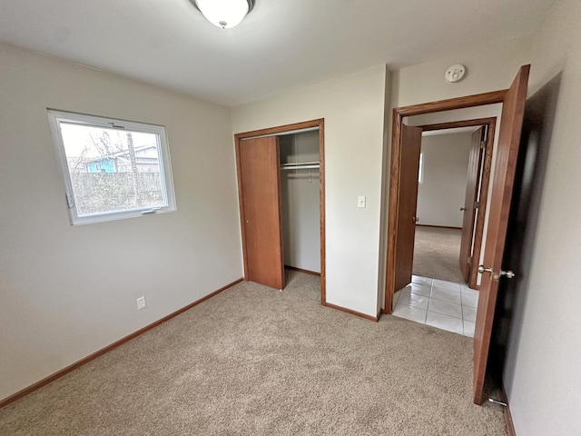 unfurnished bedroom featuring light colored carpet and a closet