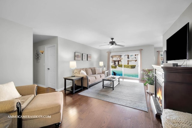 living room with ceiling fan and dark hardwood / wood-style floors