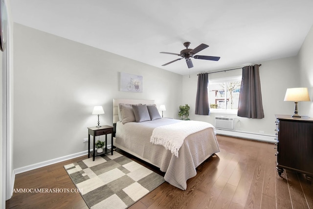 bedroom featuring ceiling fan, a wall mounted AC, a baseboard radiator, and dark hardwood / wood-style floors