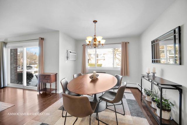 dining space featuring a wall mounted air conditioner, a chandelier, and wood-type flooring