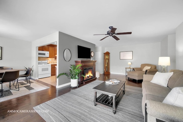 living room featuring ceiling fan and light wood-type flooring