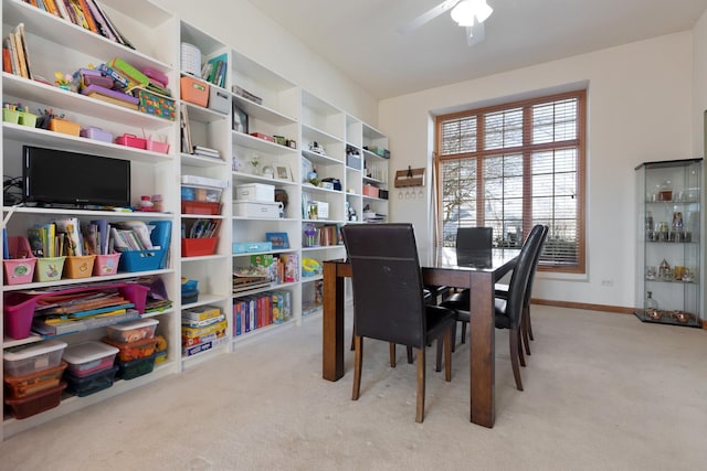 dining space with ceiling fan and light carpet