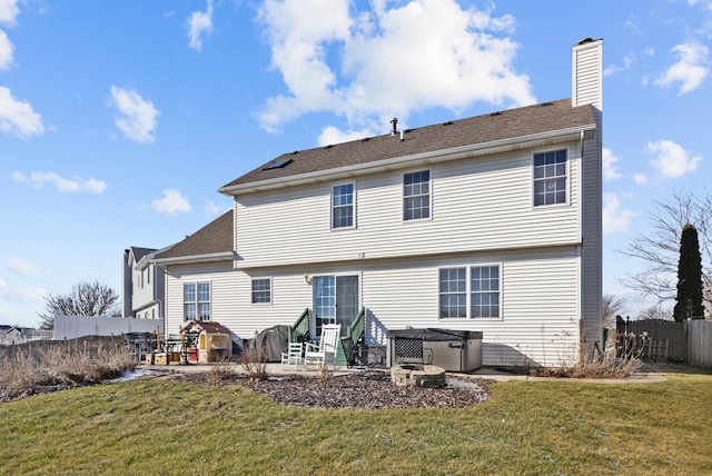 back of house with a patio and a lawn