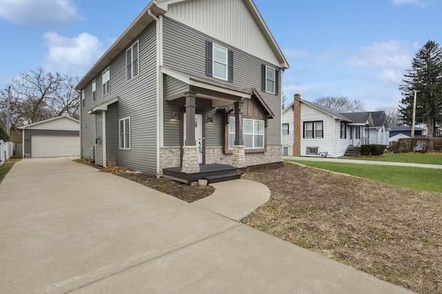 view of front of property with a garage, an outdoor structure, and a front yard