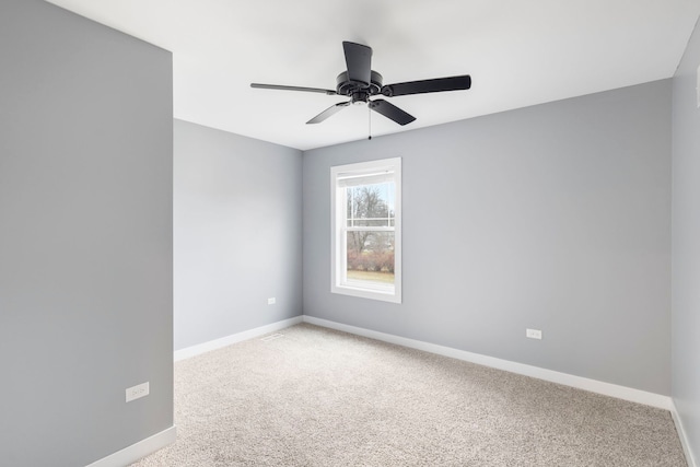 empty room featuring ceiling fan and carpet floors