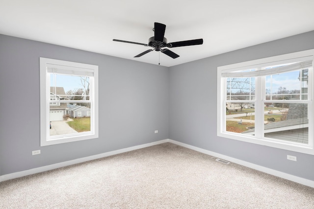 spare room with carpet, plenty of natural light, and ceiling fan