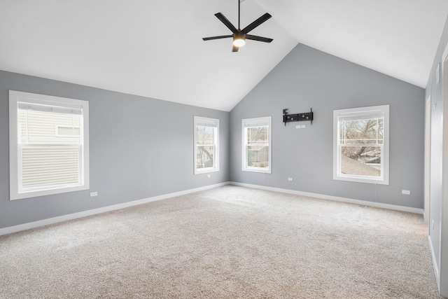 carpeted empty room with ceiling fan and vaulted ceiling