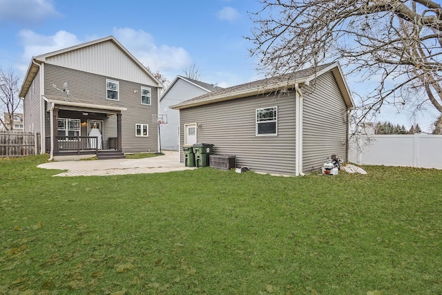 rear view of house with a patio area and a yard