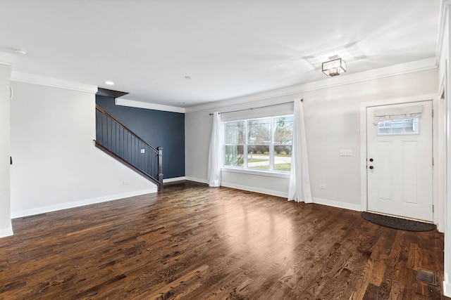 foyer entrance with dark hardwood / wood-style floors and ornamental molding