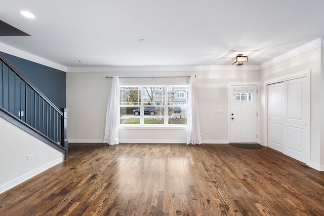 entryway featuring dark hardwood / wood-style floors and crown molding