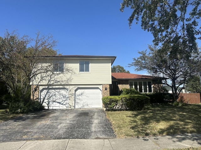 view of front of house with a front yard and a garage