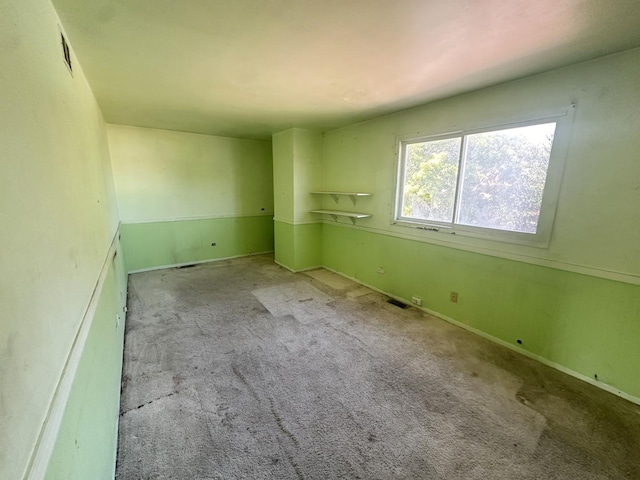 spare room featuring light colored carpet