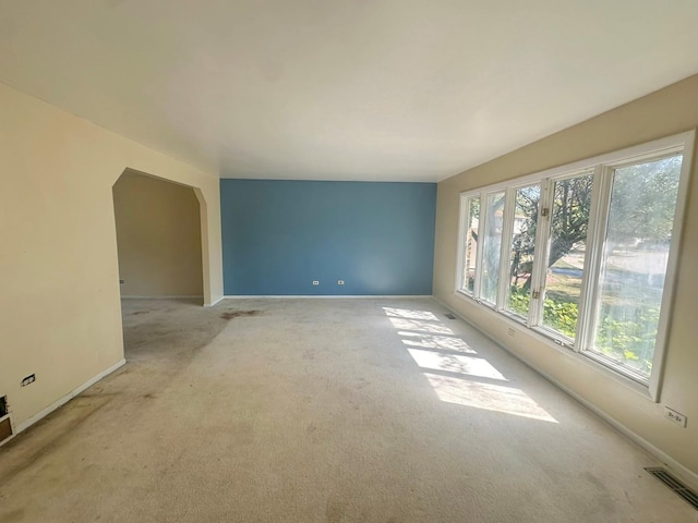 unfurnished room featuring light carpet