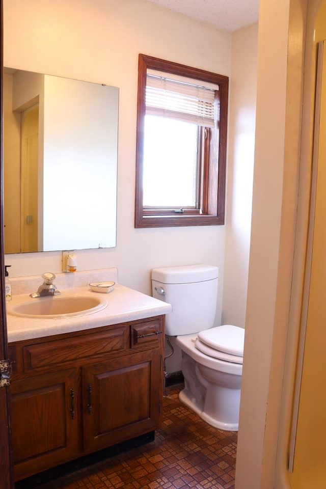 bathroom featuring vanity and toilet