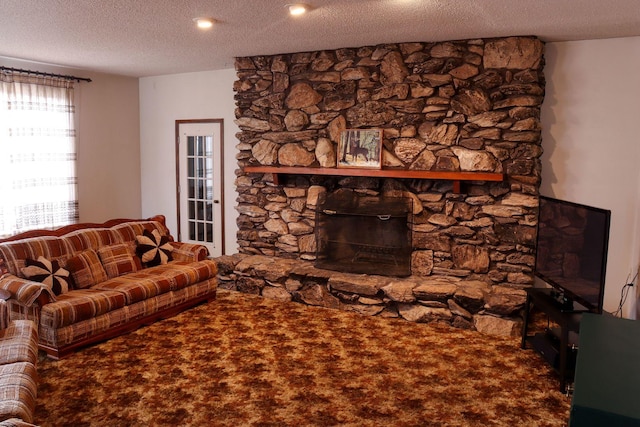 unfurnished living room with carpet flooring, a fireplace, and a textured ceiling