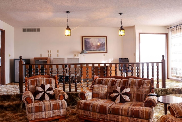 living room with carpet floors and a textured ceiling