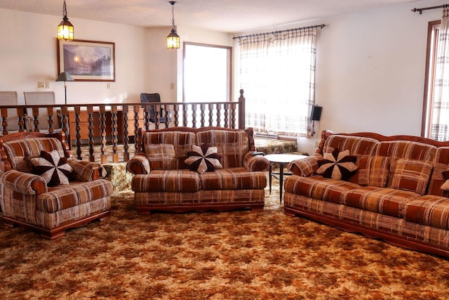 carpeted living room with a textured ceiling