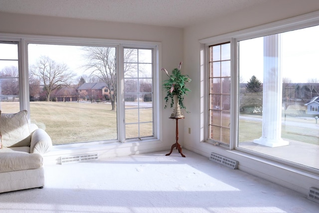 doorway with carpet floors and a textured ceiling