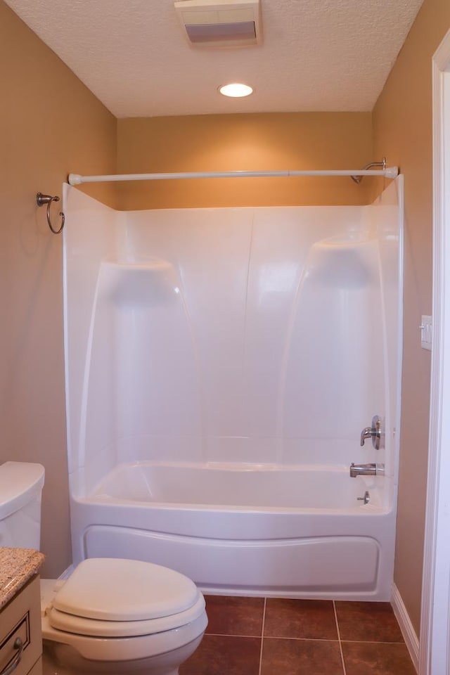 full bathroom with vanity, bathing tub / shower combination, tile patterned flooring, toilet, and a textured ceiling