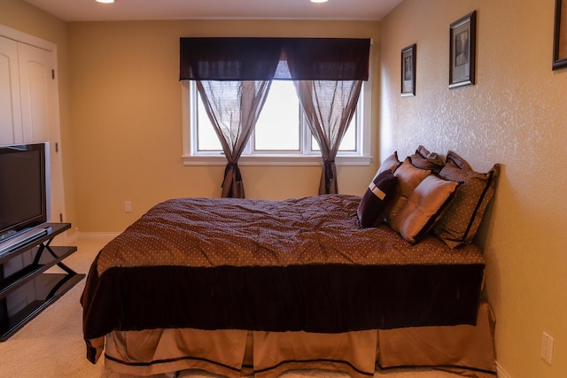 carpeted bedroom with a closet